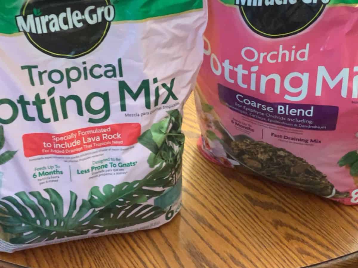 a bag of tropical potting mix and a bag of orchid potting mix
